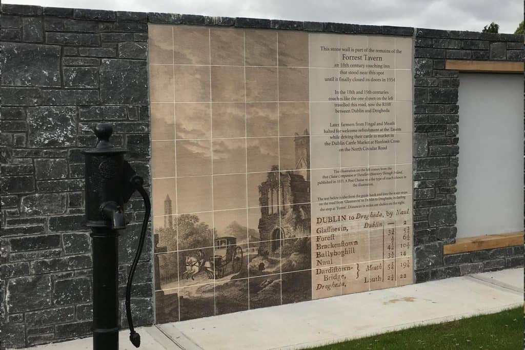 Outdoor heritage porcelain tile mural on a stone wall at Dublin Airport